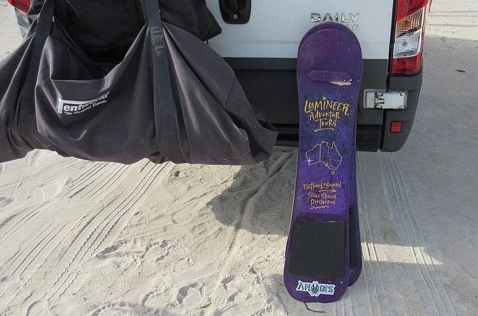A sandboard propped against a vehicle on the Lancelin dunes