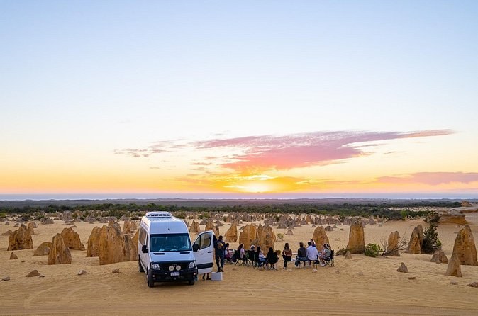 A tour coach parked at the Pinnacles as the sun drops to the horizon