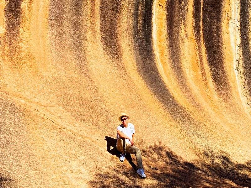 A sandboarder dropping down the face of the Lancelin sand dunes