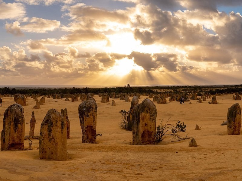 The Pinnacles lit gold under a bank of evening cloud