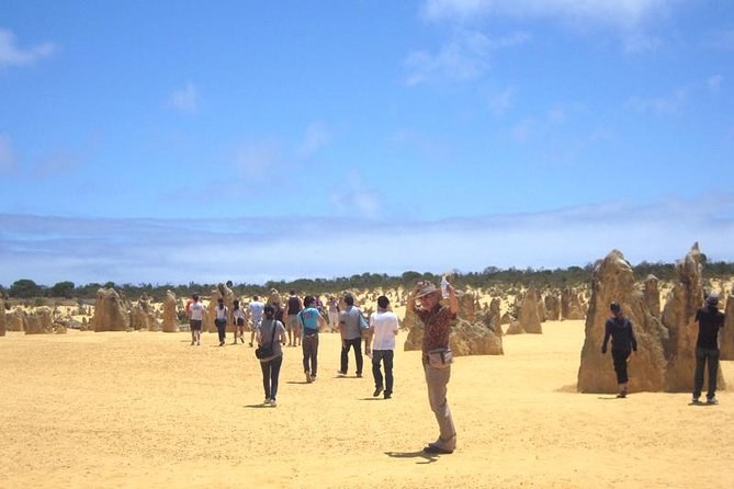 Visitors walking the marked route between the limestone pillars